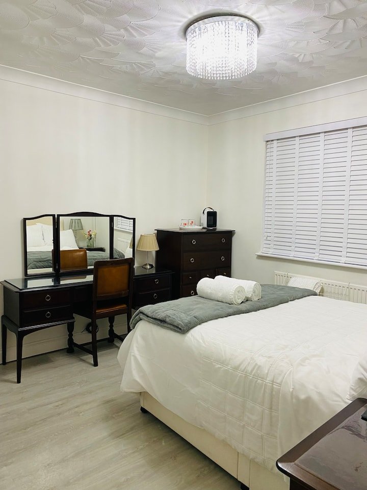 Bright double bedroom with dressing table and fresh towels