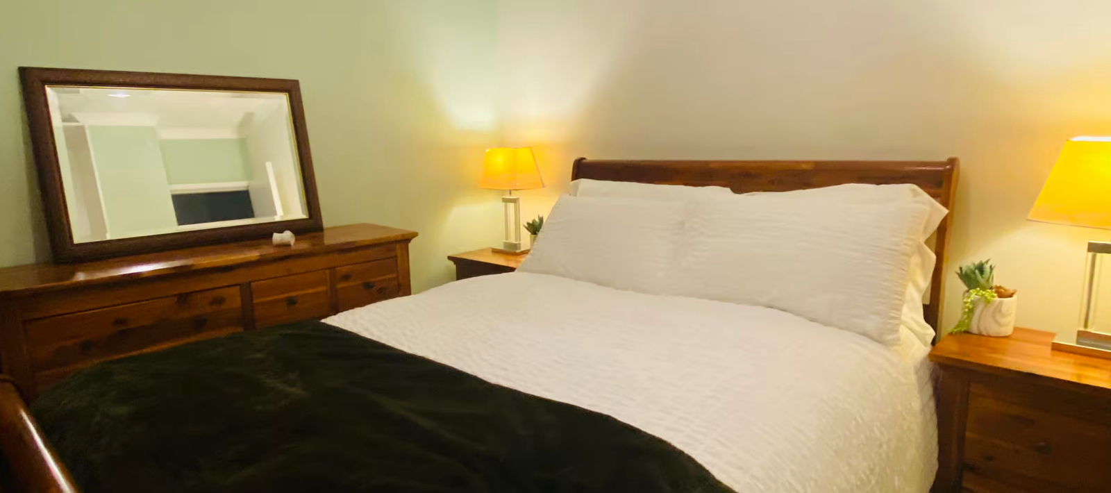 A comfortable double bedroom with bedside lamps