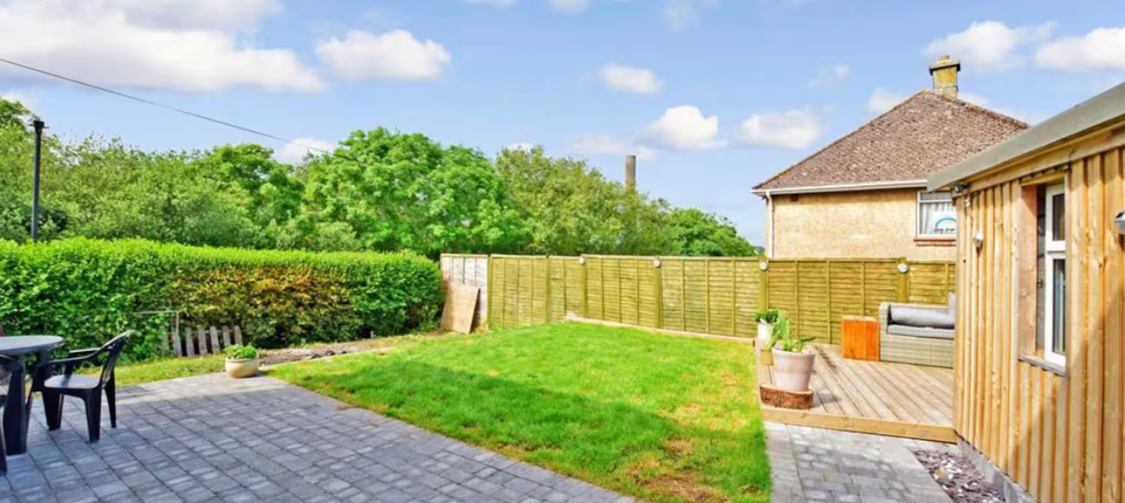 Private rear garden with lawn, patio and decked seating area